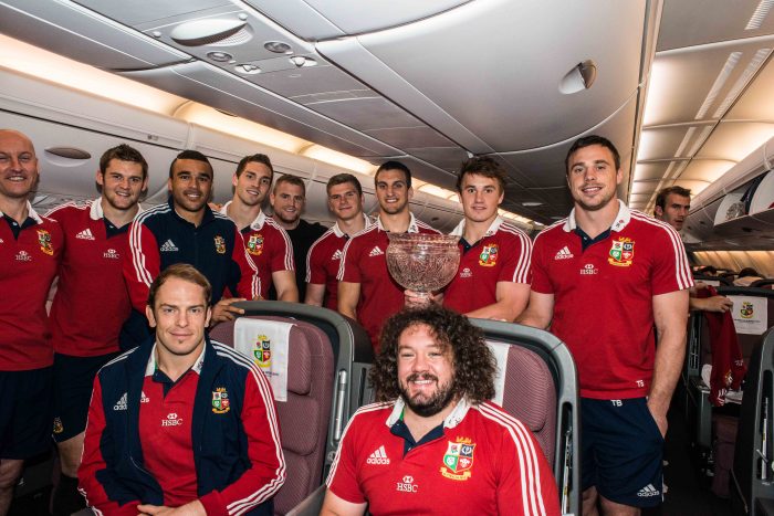 British and Irish Lions team members celebrate victory onboard Qantas' A380 to London