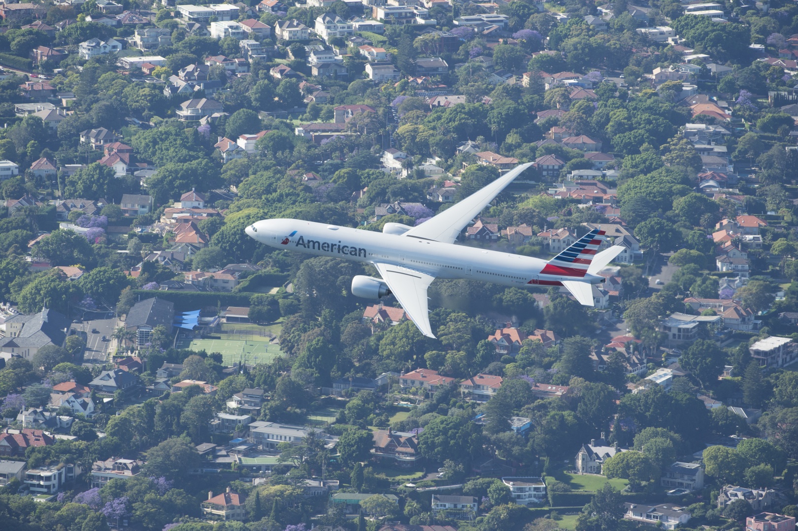 American airlines 777300er flies over Sydney Harbour ahead of